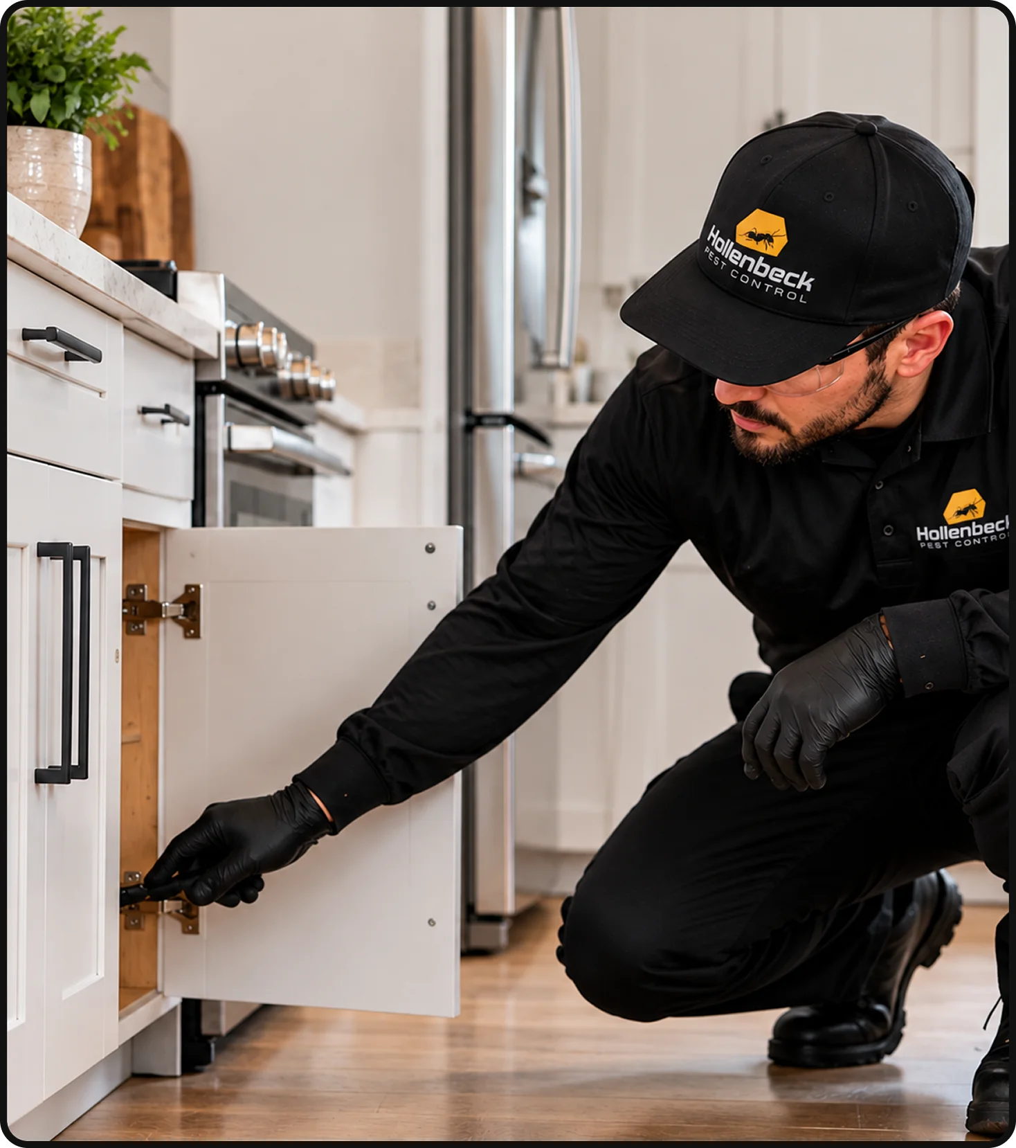 Hollenbeck Pest Control technician inspecting a kitchen cabinet for cockroaches